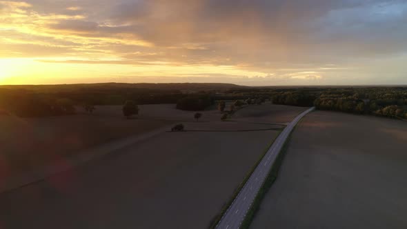 Aerial View of Country Road and Fields at Sunset