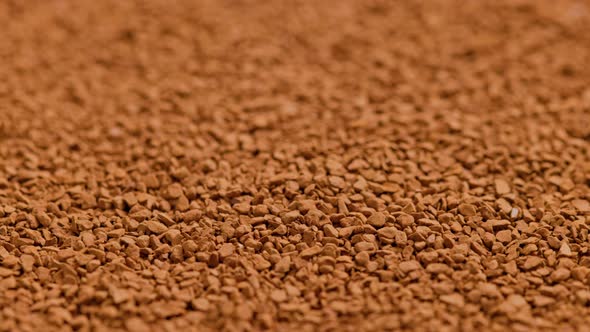 Full Frame Slowly Spinning Background of Freezedried Instant Coffee Granules Extreme Closeup with