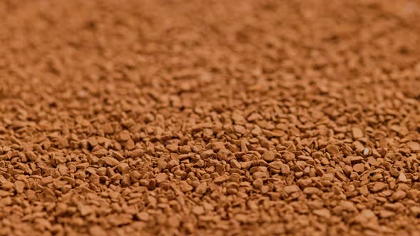 Full Frame Slowly Spinning Background of Freezedried Instant Coffee Granules Extreme Closeup with alt