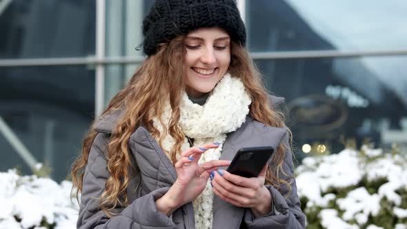 Curly Female Using Smartphone Standing Outside Smiling Happy Girl Employee Typing on a Cellphone