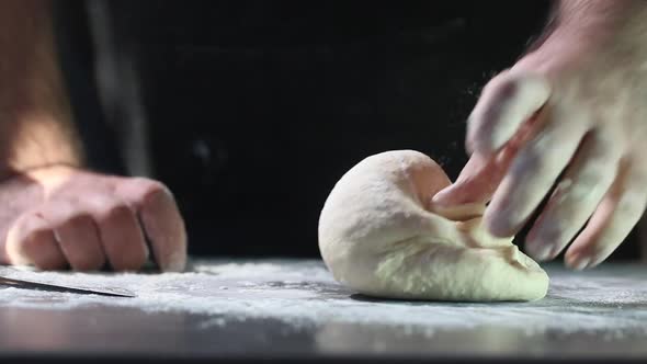 Man kneading dough with his hands, closeup hd video