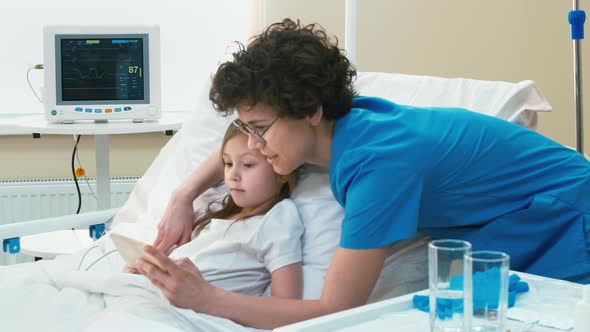 Nurse watching mobile phone's display with little patient