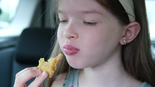 Little Girl Eating Chicken Nuggets in the Car Fast Food