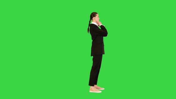 Young Woman Adjusting Her Office Suit Crossing Arms on a Green Screen Chroma Key