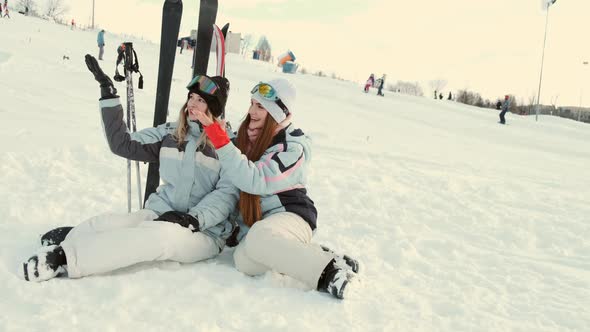 Two Gorgeous Laughing Young Woman at Ski Resort alt