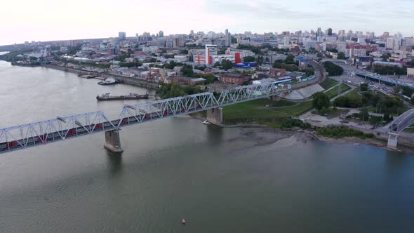 Train Travels Along the Railway Bridge Across the Ob River in Novosibirsk alt