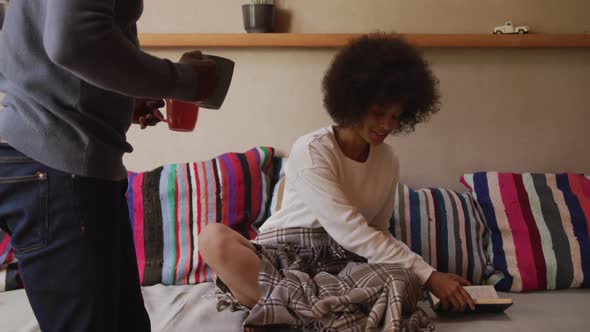 Couple drinking coffee in the living room alt