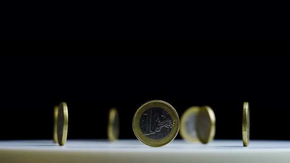 Motion Around Set of Shiny Euro Coins Standing on Ribs alt