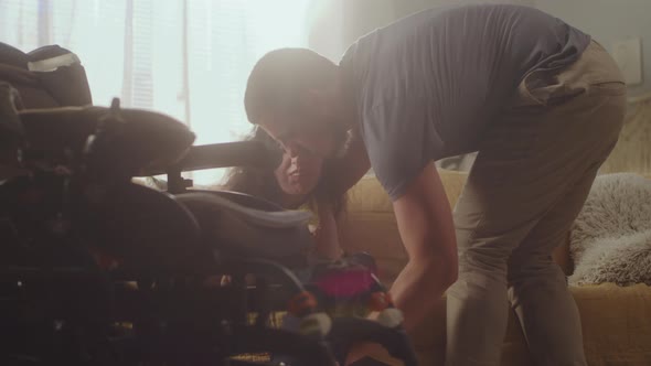 Husband Putting His Wife in Wheelchair alt