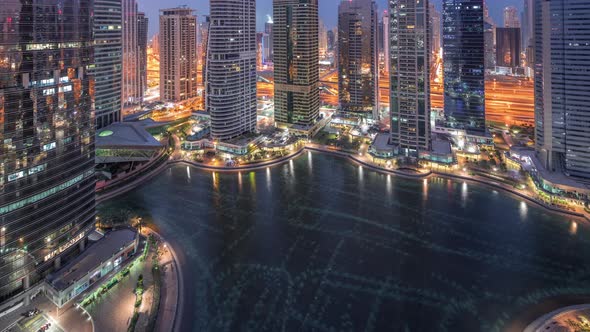 Residential and Office Buildings in Jumeirah Lake Towers District Night to Day Timelapse in Dubai alt