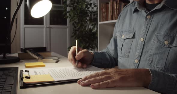 Man Reading Contract at Home Office