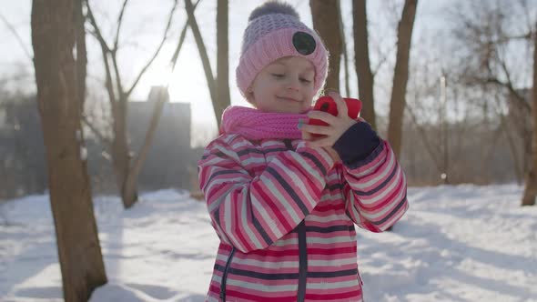 Child Girl Vlogger Making Video Call Chatting with Friends Distance Communication in Winter Park alt