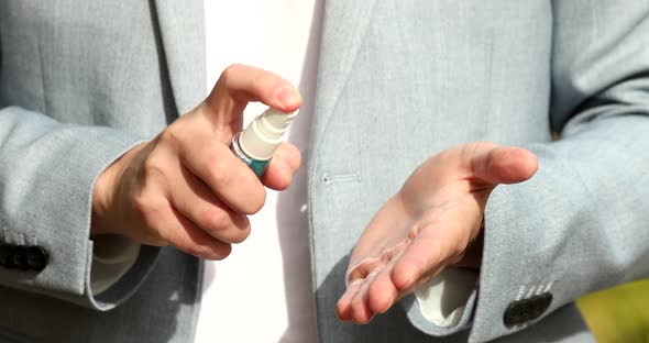 Close up of men hand  by using alcohol sanitizer.
