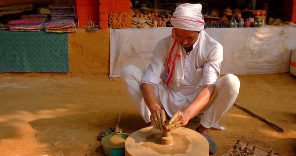 Skilled Professional Potter Throwing the Potter's Wheel and Shaping Traditional Ceramic Vessel and alt