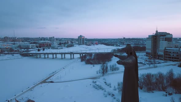 The Monument Of The Patron Mother In Cheboksary, Against The Background Of The City alt