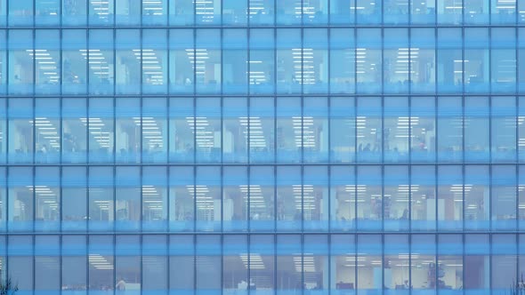 Timelapse of the exterior of an office block at night 