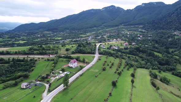 Aerial Drone Footage Moving Forward to a Rural Village Close to Mountains