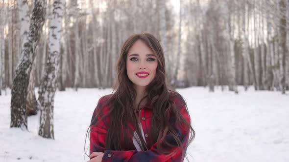 Charming Female with Long Hair Walking in Snowy Forest