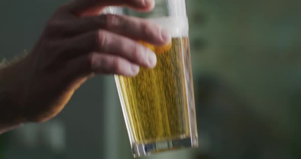 Glass of Beer in a Man's Hand