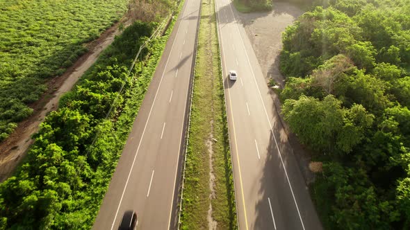 Aerial view while car travels in beautiful terrain. Cars Driving on an asphalt road.