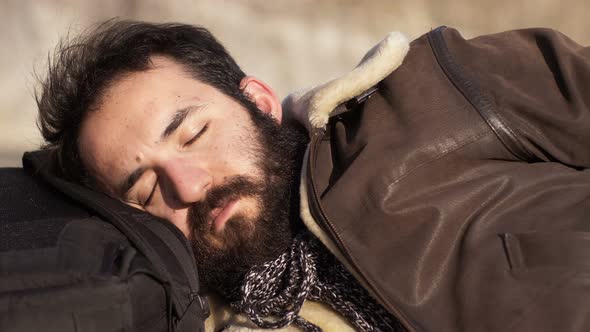 Relaxing,sleeping,sun- bearded man sleeps in the sun. alt
