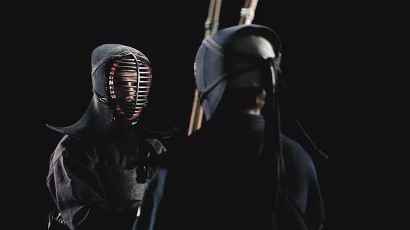 Kendo Fighters with Bamboo Swords on a Black Background alt