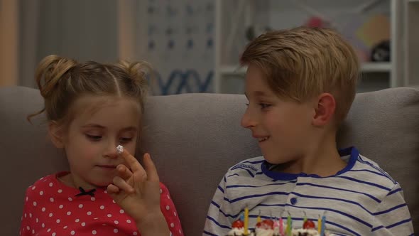 Brother Putting Birthday Cake Cream on Sisters Nose, Fooling Around, Happiness alt