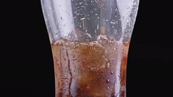 Cold Soda in a Glass with Ice Close Up