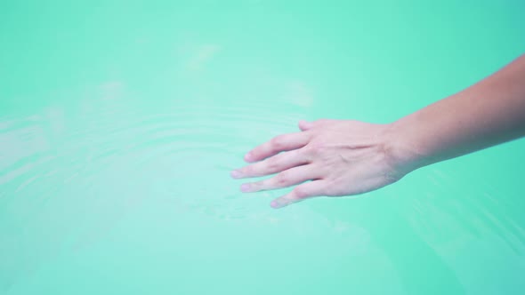 A Young Woman Sliding Over the Water in the Pool alt
