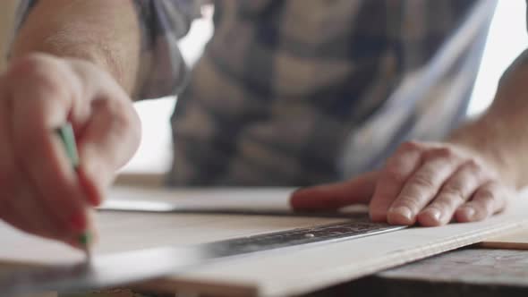 Carpenter Makes Pencil Markings on the Blank with the Help of a Ruler