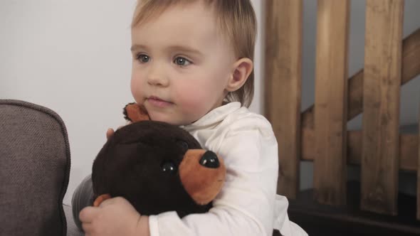 Portrait of Cute Little One Year Old Girl Laughing Happily While Playing and Hugging with Her Mother alt