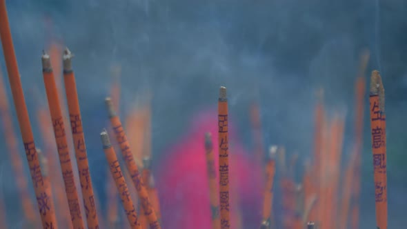 Incense Sticks are Burning Slowly in the Burner of a Chinese Temple alt