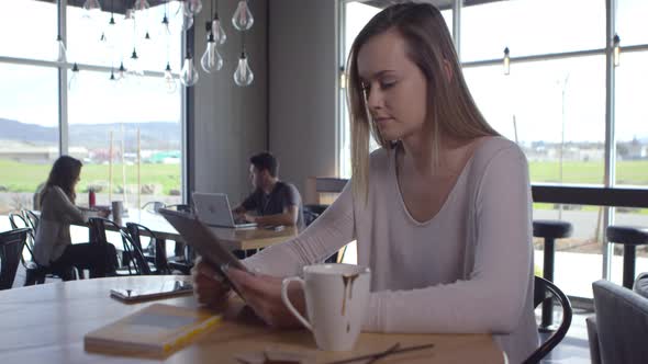 Young business woman working on tablet in shared workspace