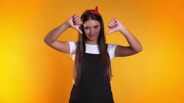 Young Pretty Woman Standing on Yellow Studio Background Expressing Discontent alt