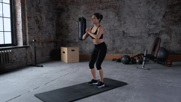 Young Indian Athletic Woman Doing Sports Doing Squat Exercise, Wearing Sportswear Black Top  alt