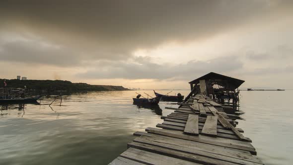 Timelapse beautiful sunrise with sun ray at fisherman wooden hut. alt