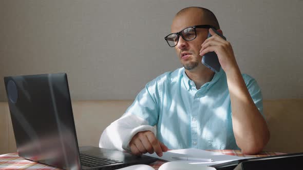 Man with Broken Arm Calling Insurance Company alt