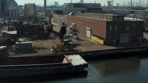 Trucks Bringing Loose Material to Transhipment Point in Industrial Site alt