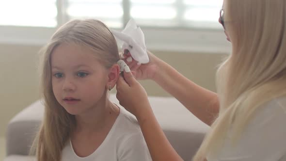 Mother Combing Her Daughter's Hair