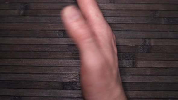 the Person Turns His Hand Up with the Palm on Which There Is a Pirate Black Mark of Death alt