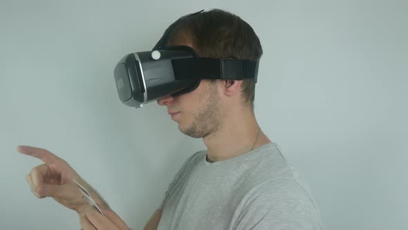 Man in a Virtual Reality Helmet Uses a Credit Card