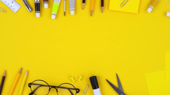 Colorful DIY equipments and stationery on yellow background top view with copy space