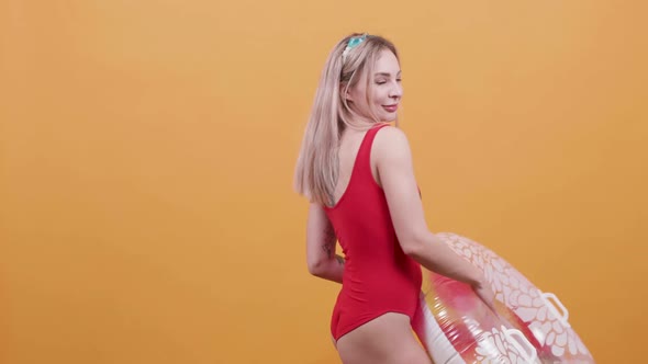 Blonde Young Woman with a Swim Ring Dances in Slow Motion alt