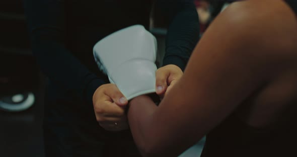 Darkskinned Fighter of MMA and His Coach are Preparing to Fight Putting Glove Closeup  Prores alt