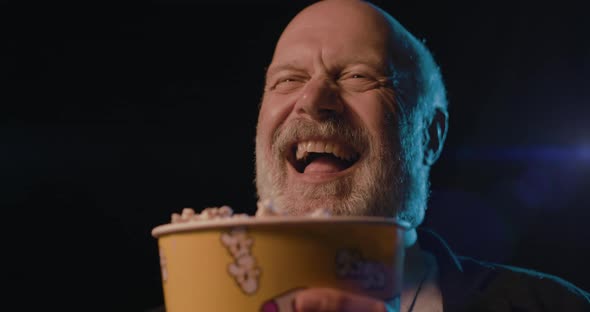 Senior man at the cinema, he is watching different movie genres and eating popcorn, video montage