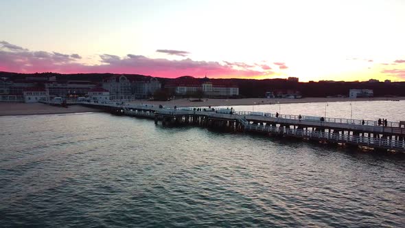 Cinematic pier in the sunset from a bird's eye view. Filming at sunset in Sopot.