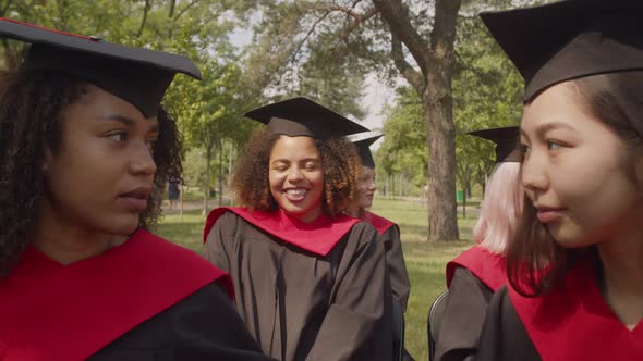Portrait of Smiling Lovely Black Female Student in Academic Dress at Graduation Ceremony alt