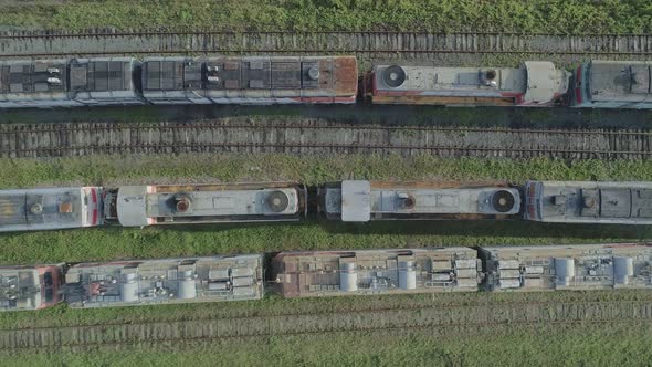Aerial Top Down Shot of an Abandoned Rusty Locomotives and Old Railways alt