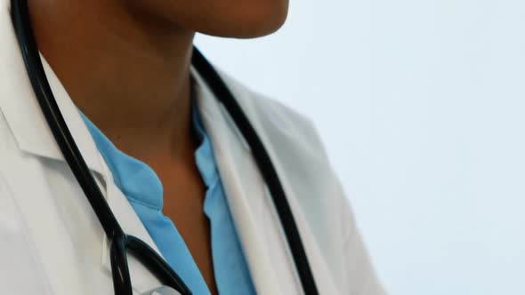 Smiling doctor looking at camera in hospital alt