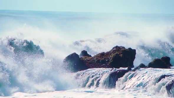 Wall of Water and Turbulent Waves of Pacific Ocean and Rugged Beauty of Basalt Rocks Reef and Cay